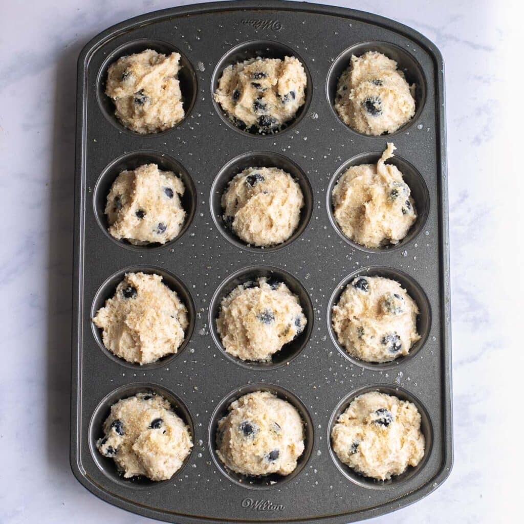 muffin batter in a muffin tin before baking