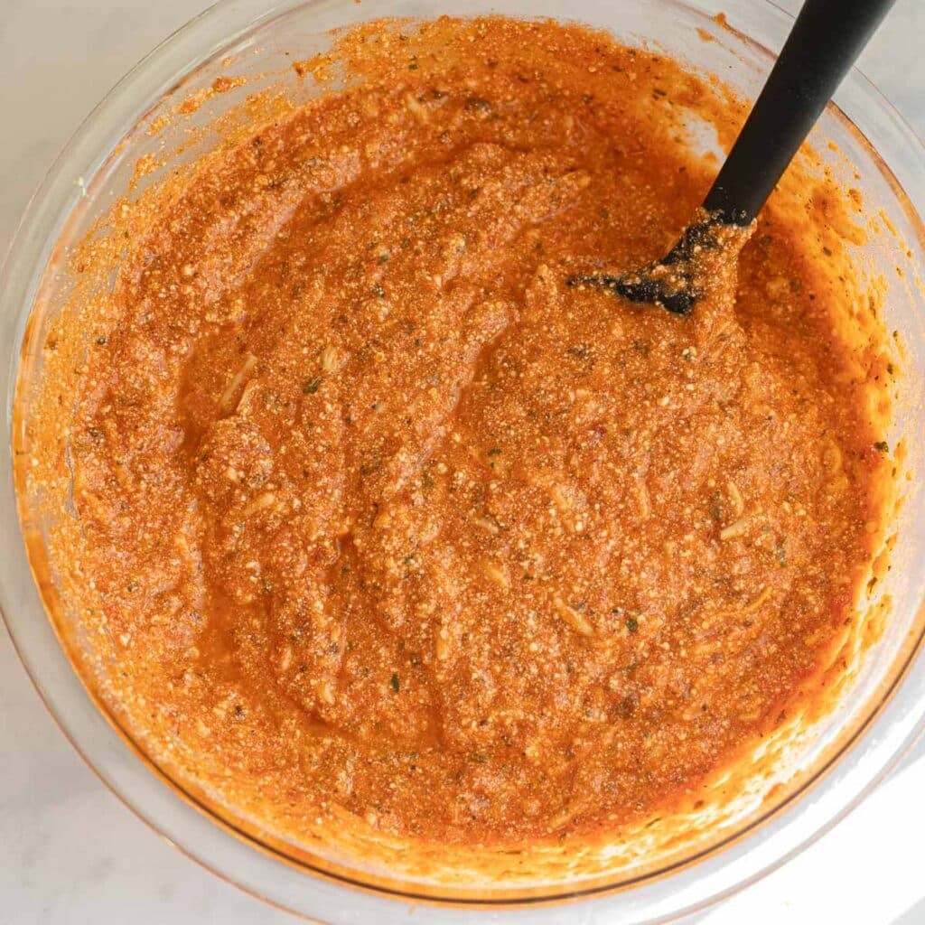 tomato sauce and ricotta cheese in a mixing bowl