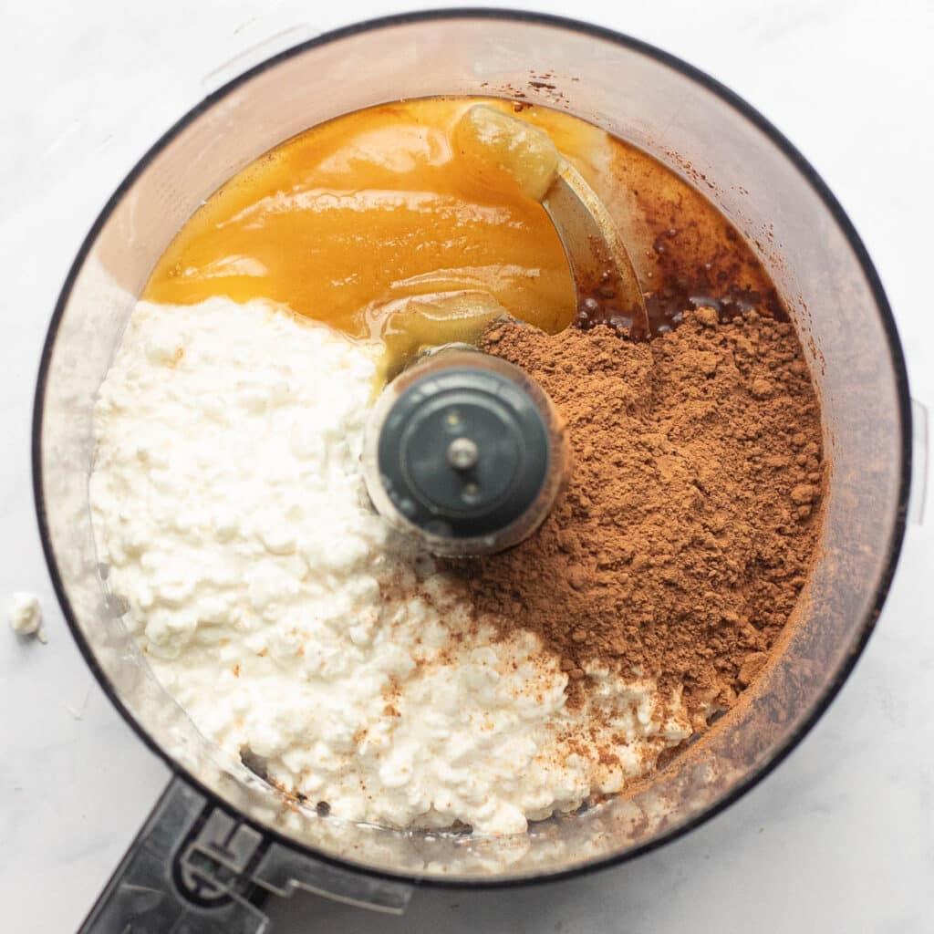 cottage cheese, cocoa powder and honey in the bowl of a food processor