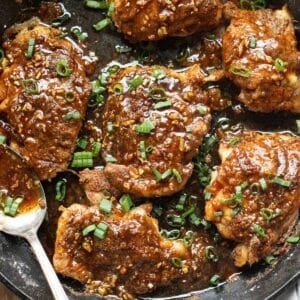 honey garlic chicken thighs in a cast iron pan