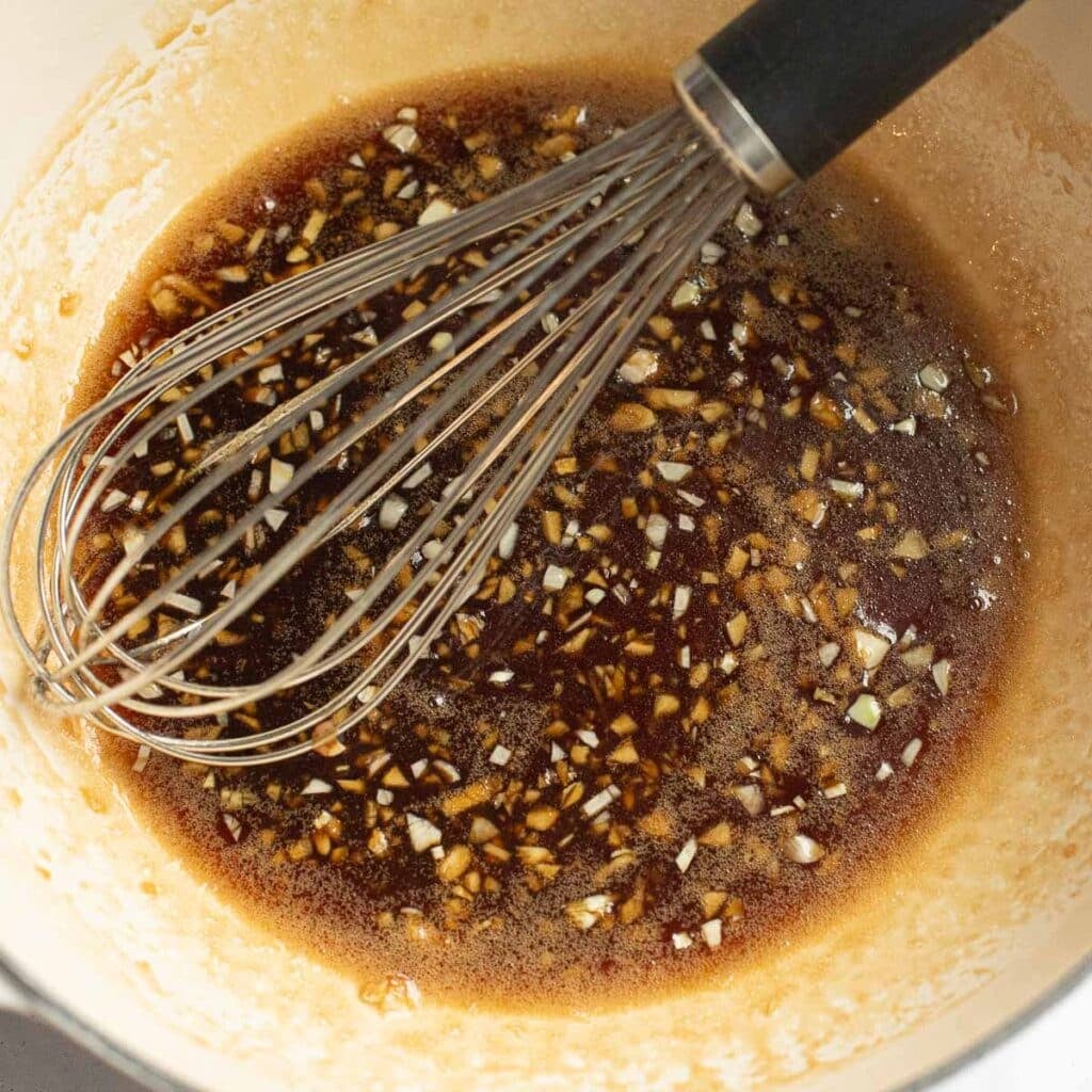 honey garlic sauce with a whisk in a pan