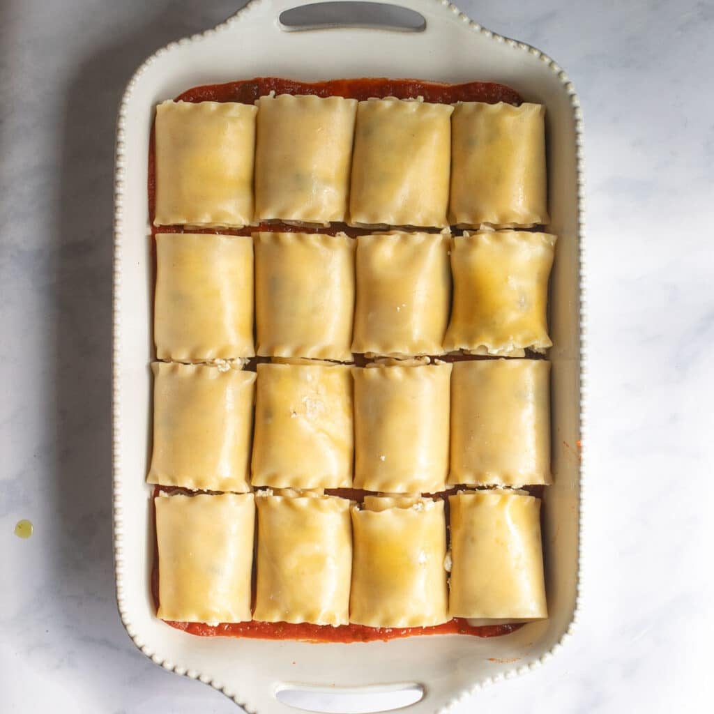 lasagna roll ups in a baking dish before baking