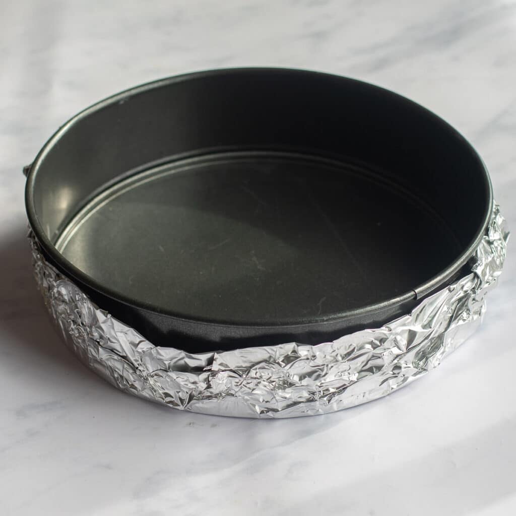 a springform pan wrapped in aluminum foil