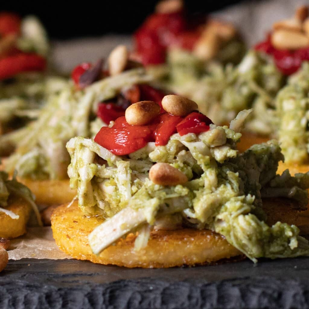 polenta rounds topped with pesto chicken and sundried tomatoes