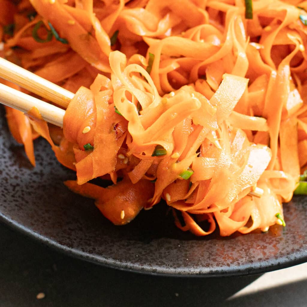chopsticks holding carrot ribbons