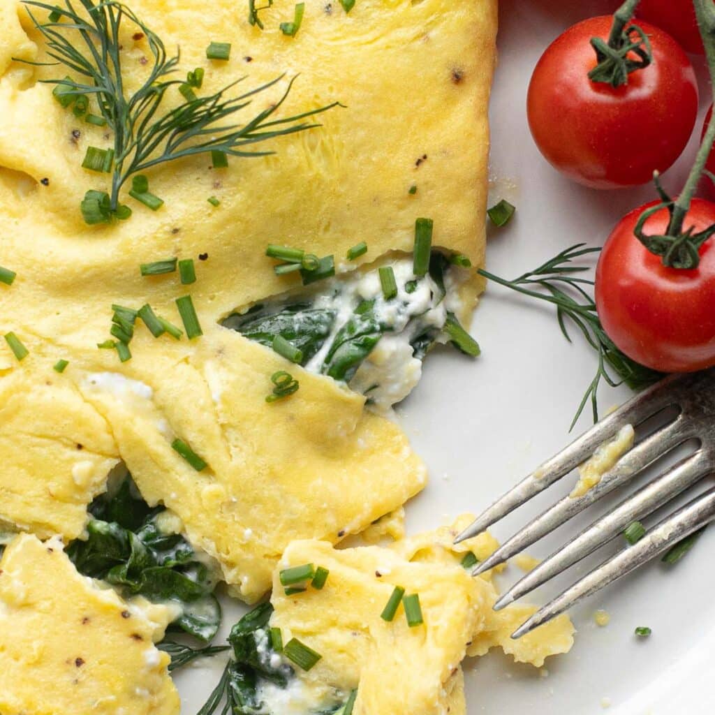 close up view of the inside of a cottage cheese omelet  with chopped chives