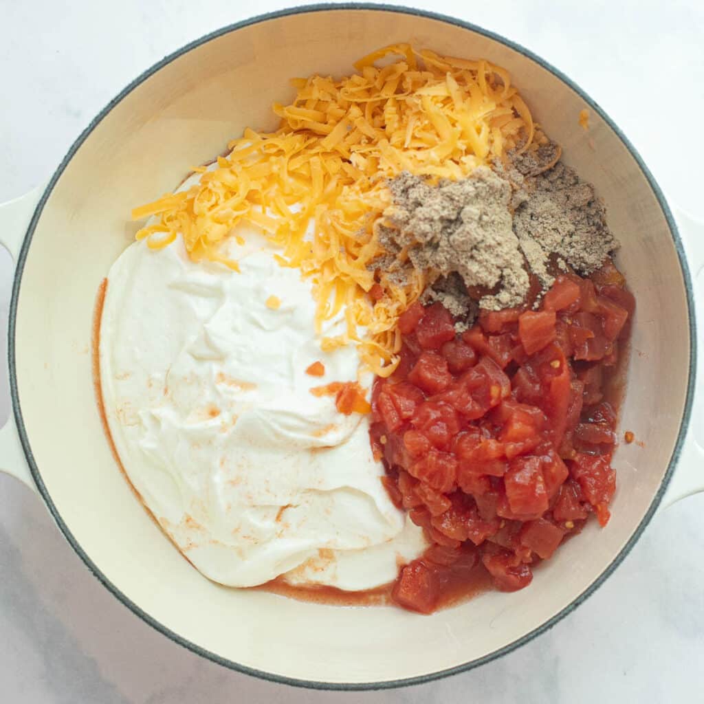 diced tomatoes, whipped cottage cheese, taco seasoning and grated cheddar cheese in a saucepan