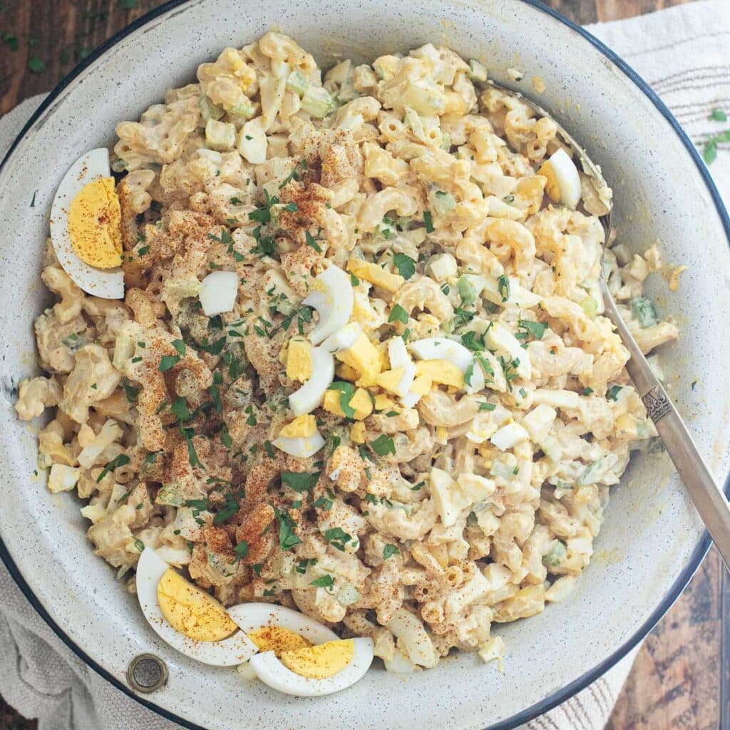 deviled egg macaroni salad in a large serving bowl