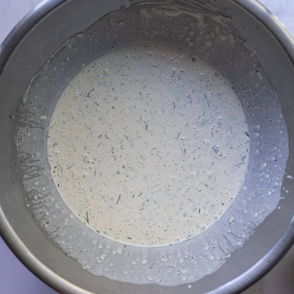 mayonnaise dressing in a silver mixing bowl