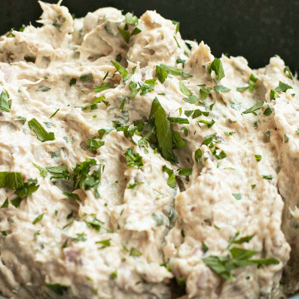 close up view of sardine dip topped with chopped parsley