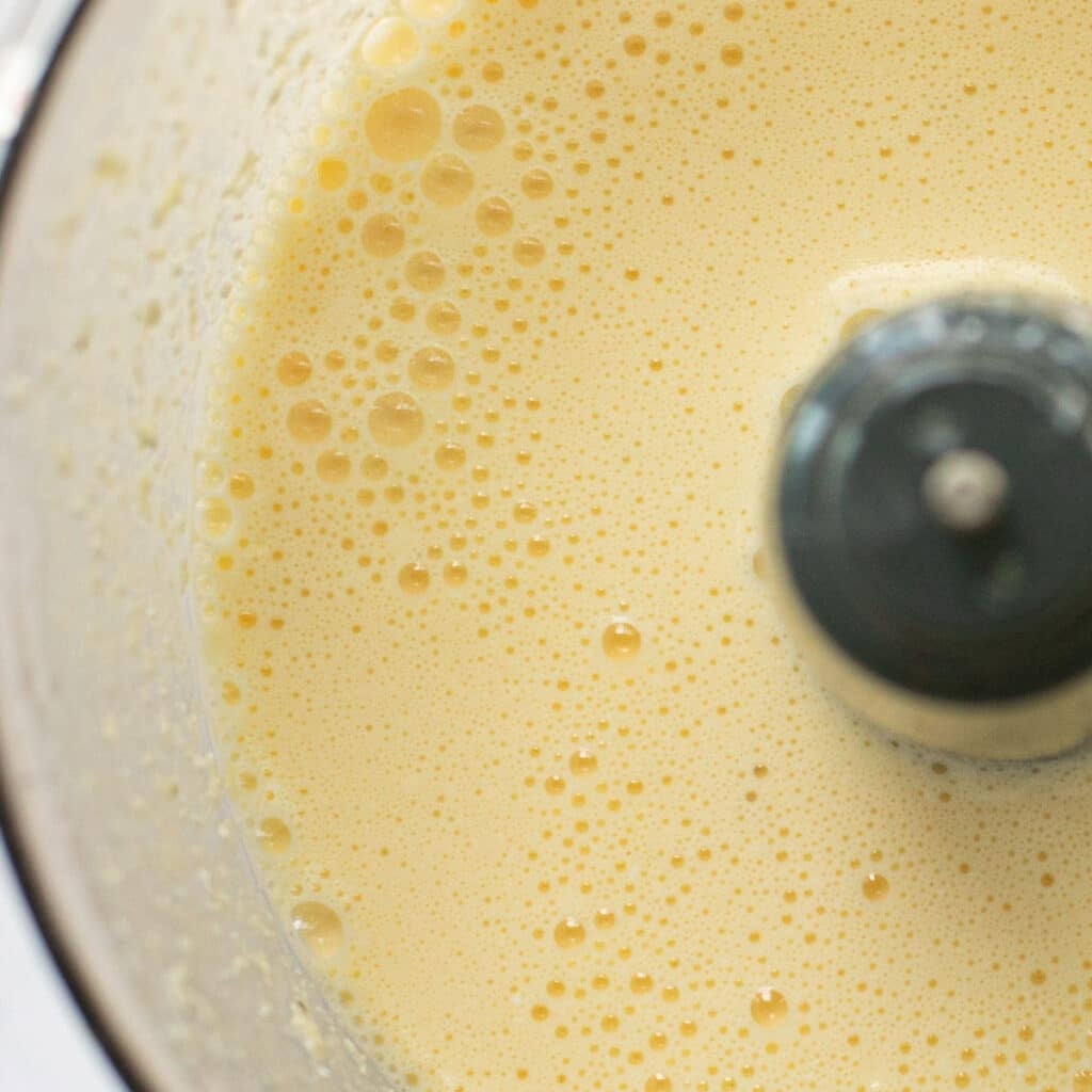 whipped eggs in the bowl of a food processor