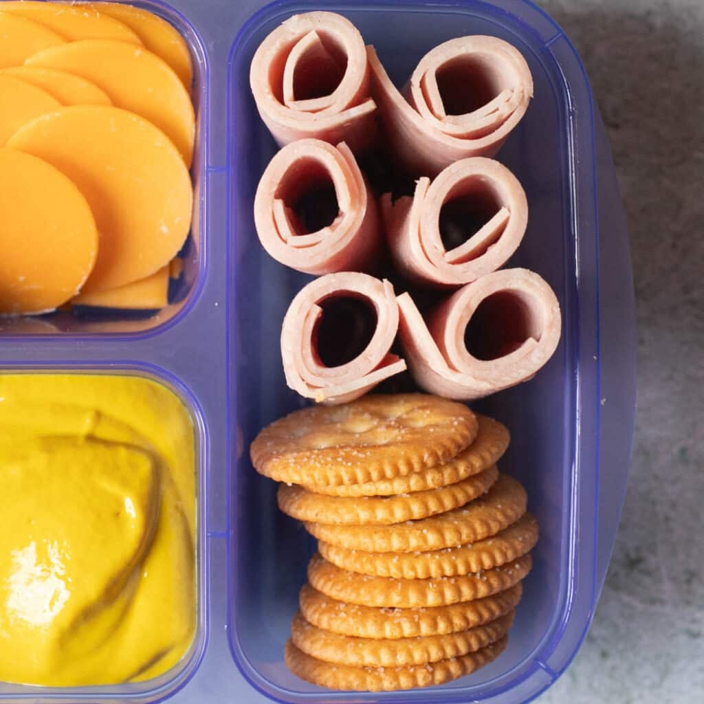 rolled up ham slices and Ritz crackers
