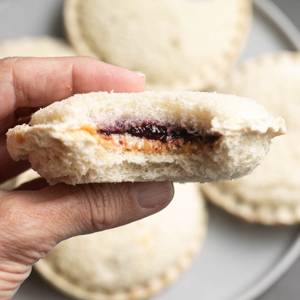 a hand holding a homemade Uncrustable