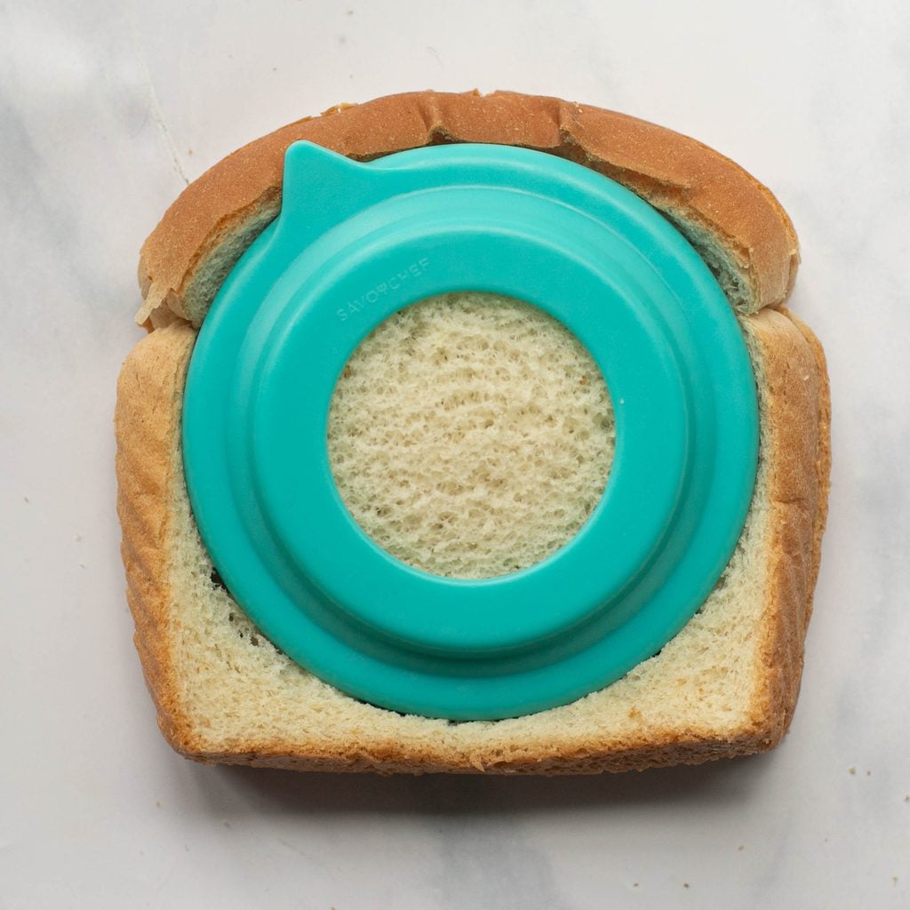 a sandwich being cut by a round sandwich cutter