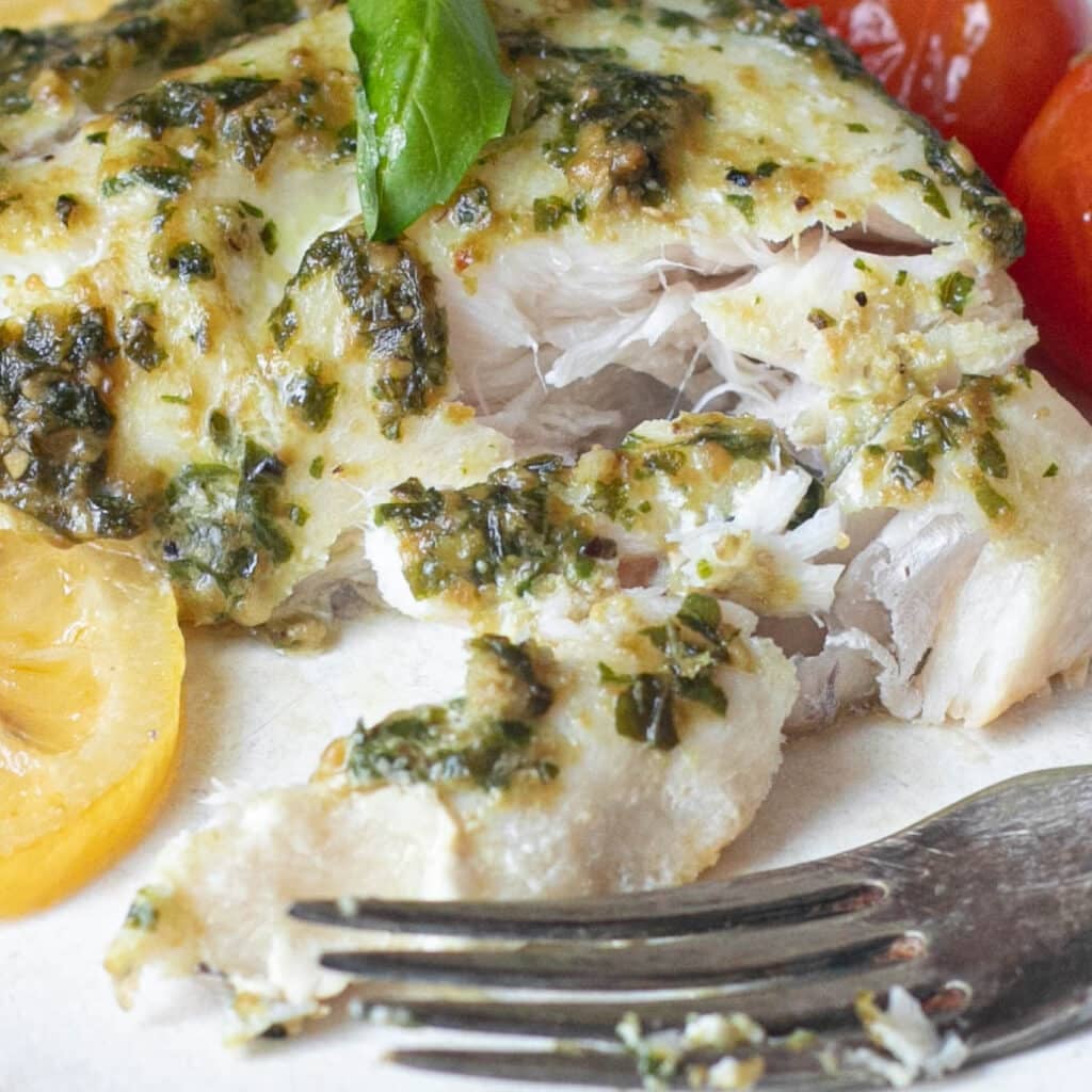flaked snapper topped with pesto sauce