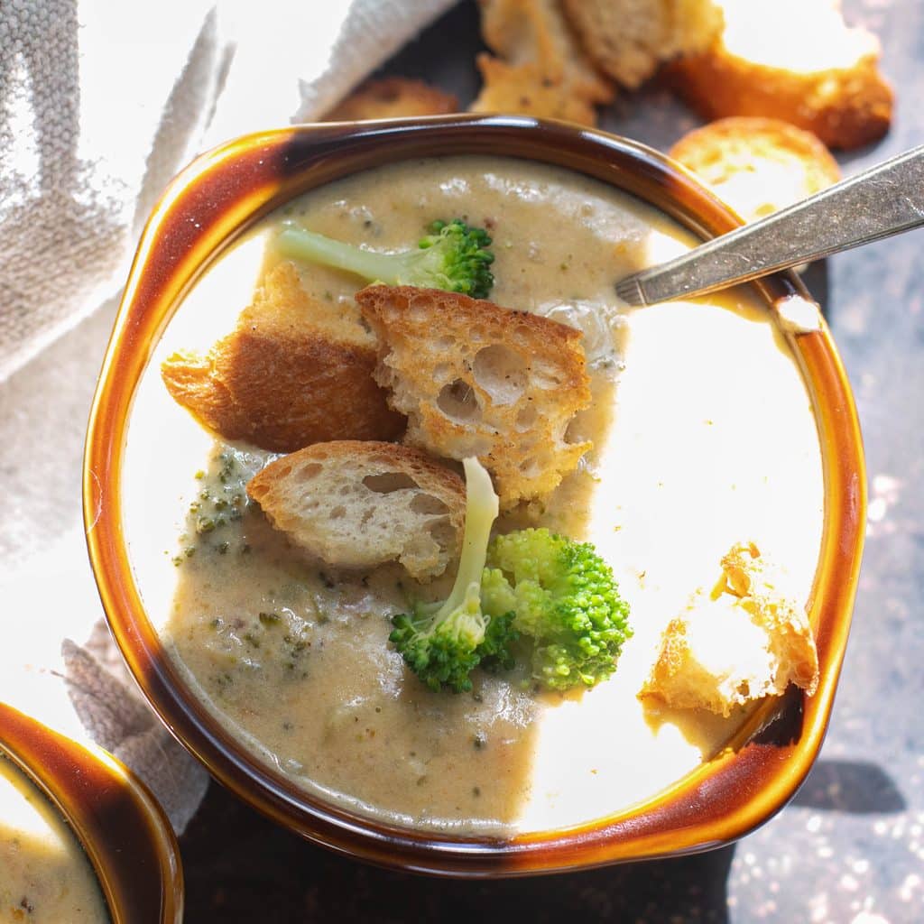 bowl of broccoli cheddar soup topped with croutons