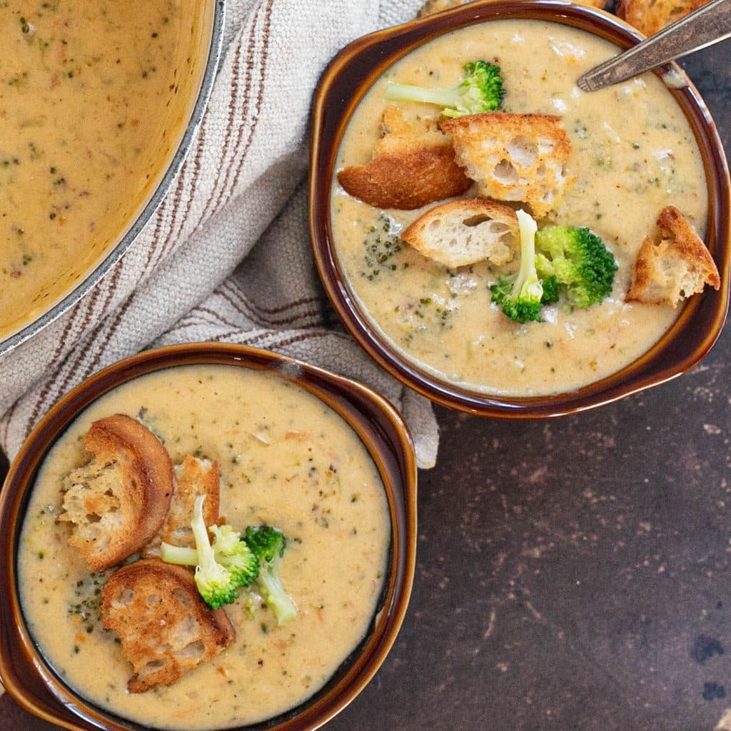 overhead view of 2 crocks of broccoli cheddar soup