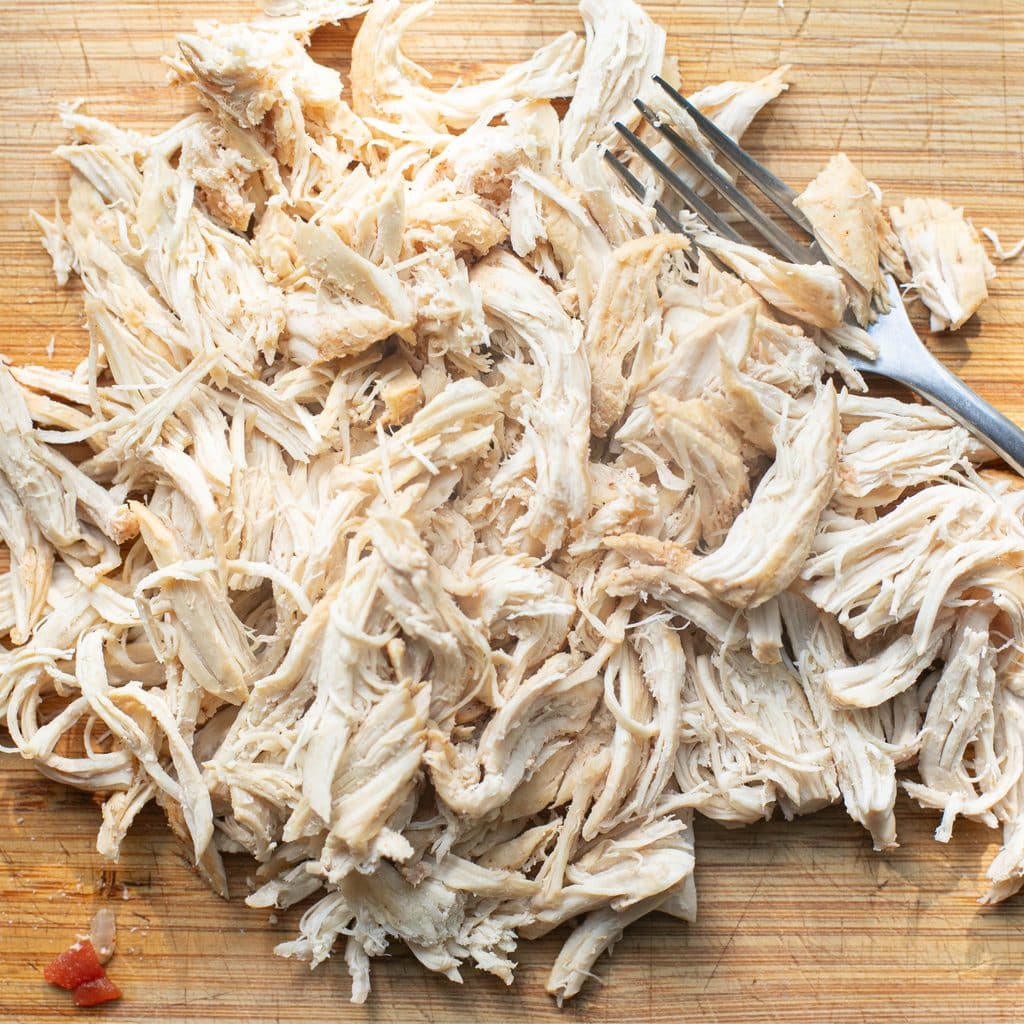 shredded chicken on a cutting board