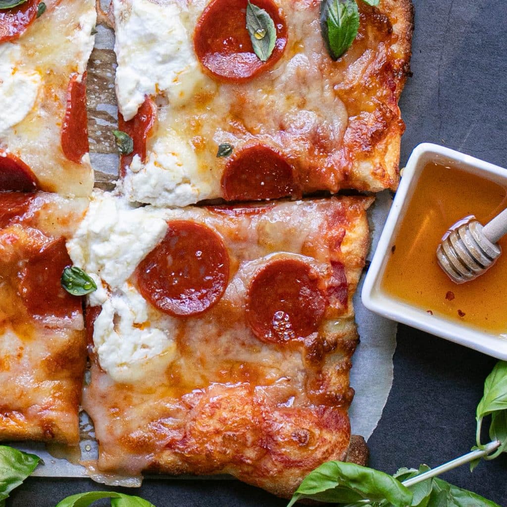 hot honey pepperoni pizza cut into squares