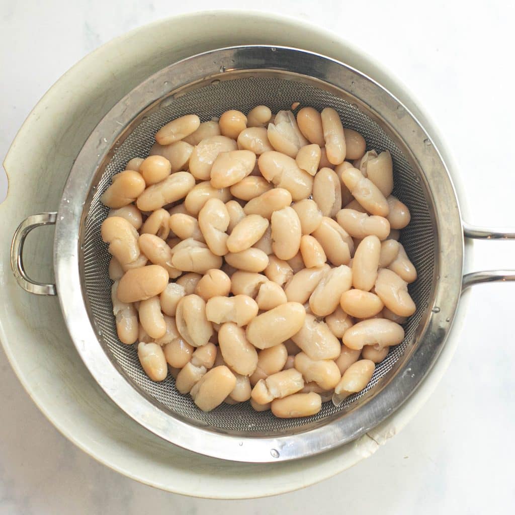 white cannellini beans in a strainer