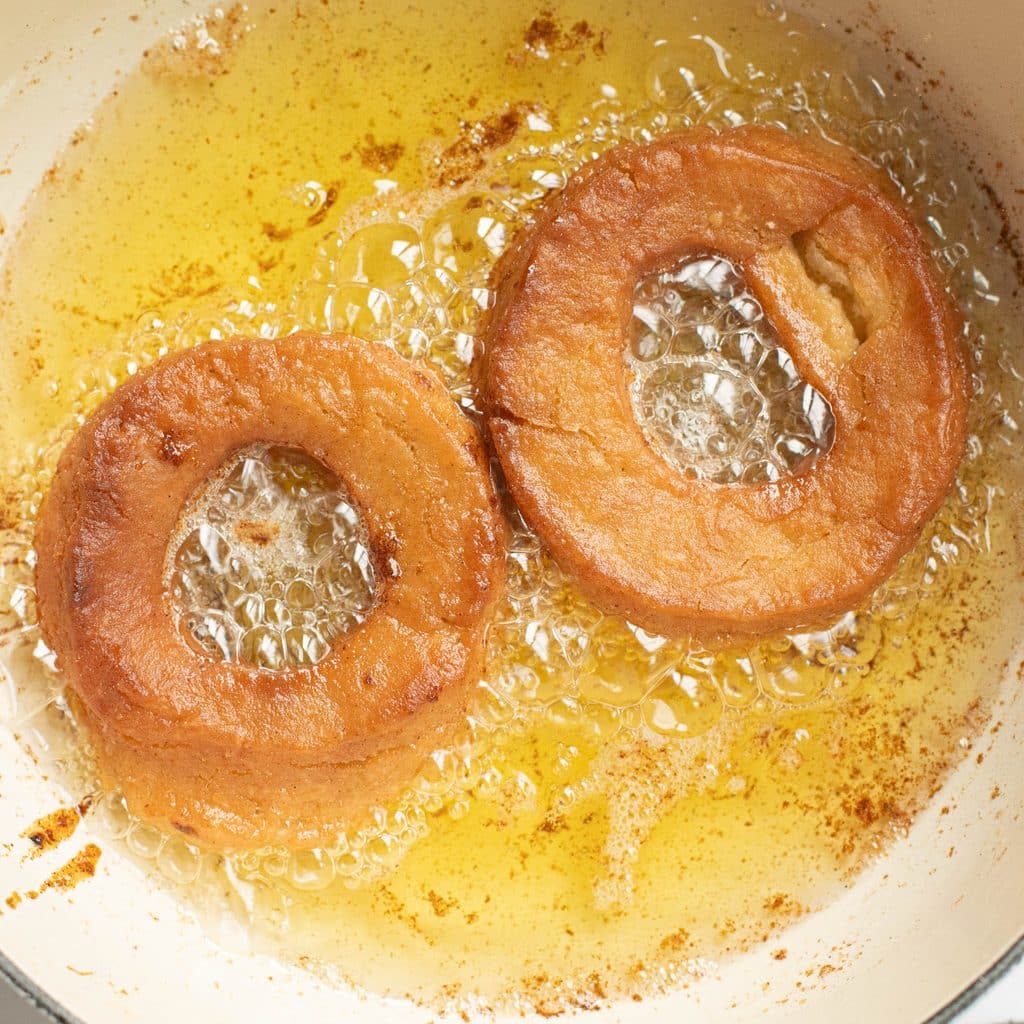 apple cider donuts frying in oil
