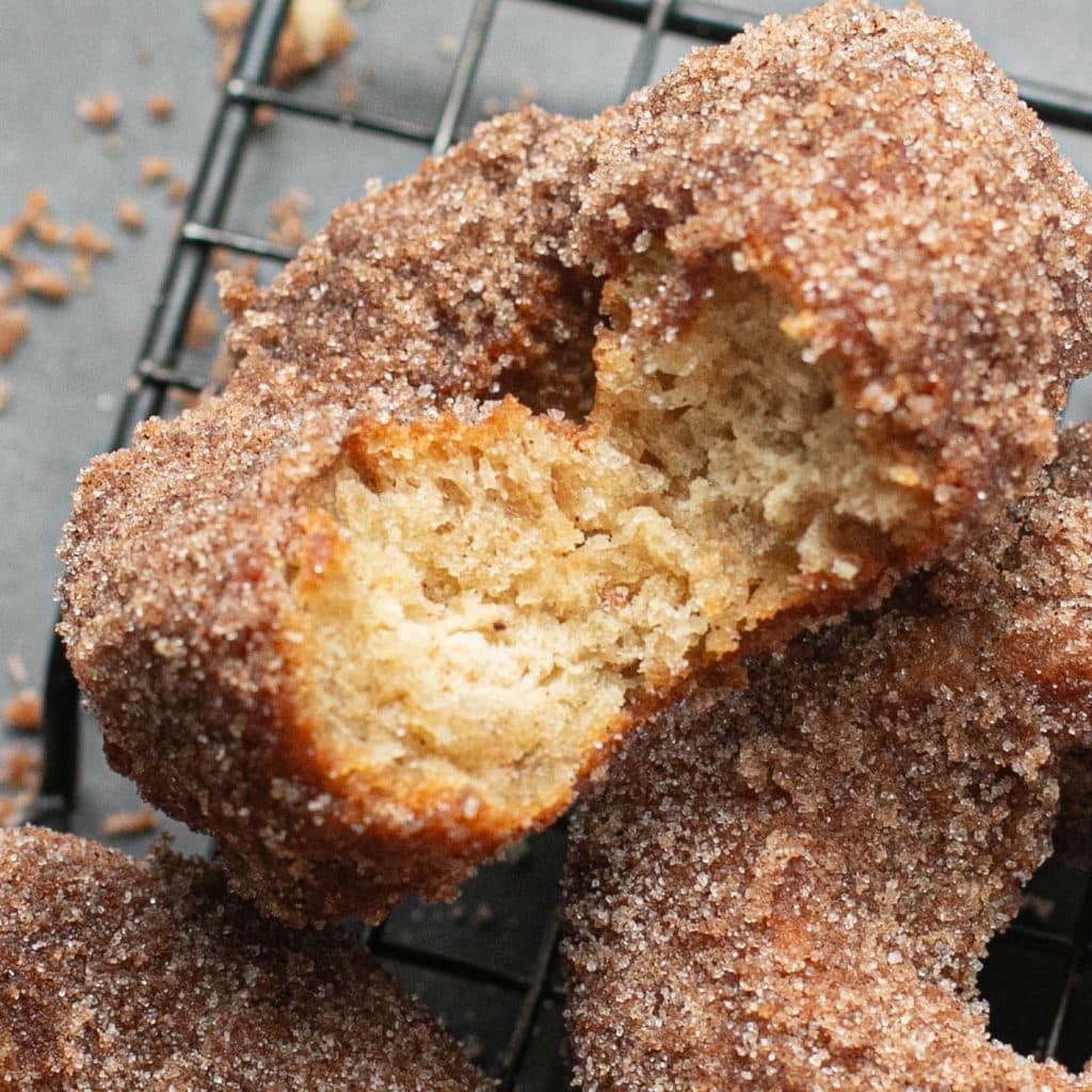 an apple cider donut with a bite taken out