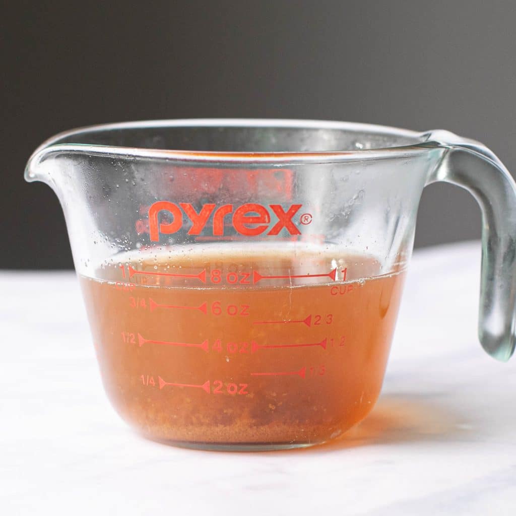 concentrated apple cider in a glass measuring cup