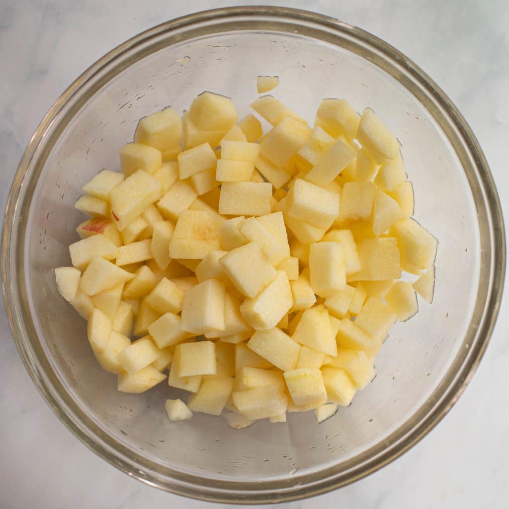 diced apples in a glass mixing bowl