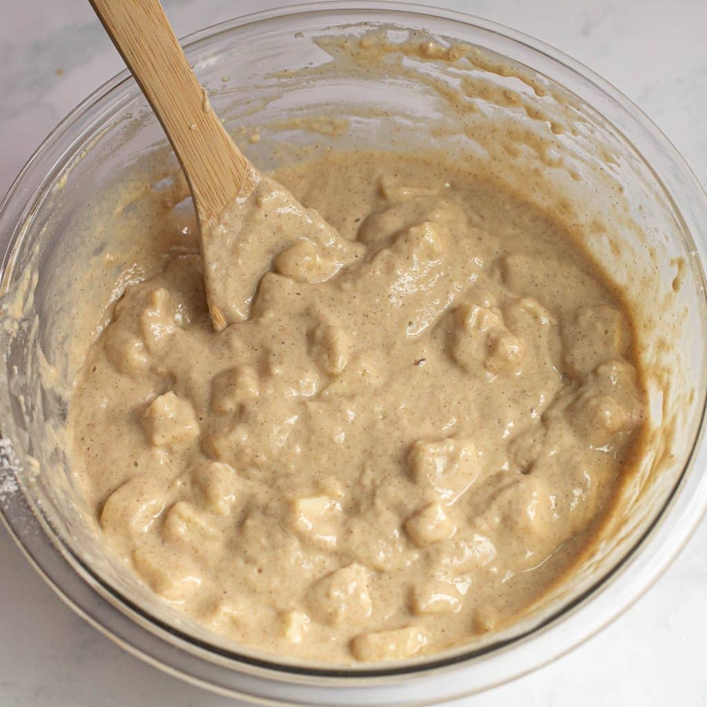 apple fritters batter in a glass bowl
