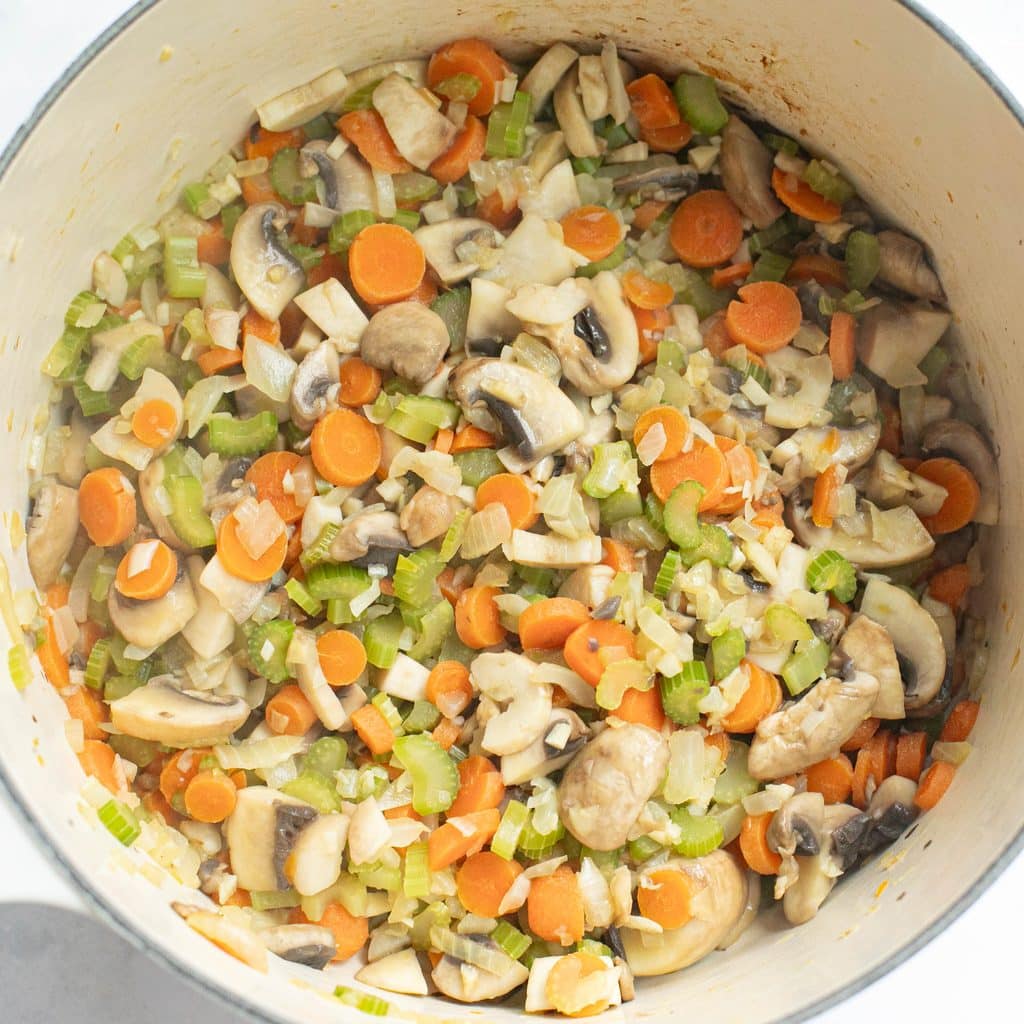 mirepoix and mushrooms in a Dutch oven