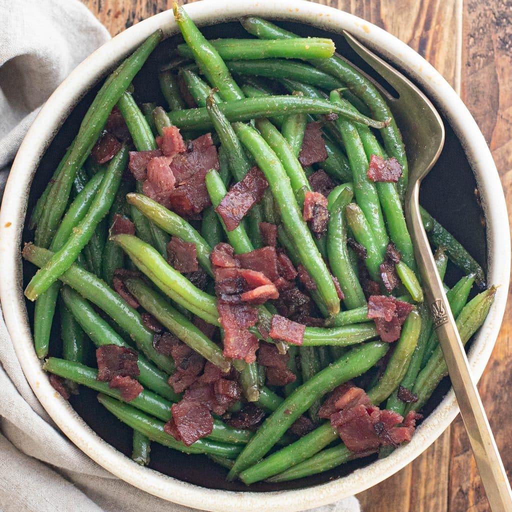 crack green beans in a serving bowl