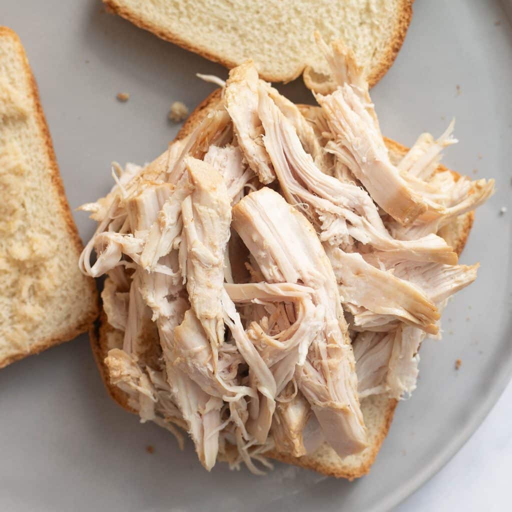 shredded turkey on a piece of white bread