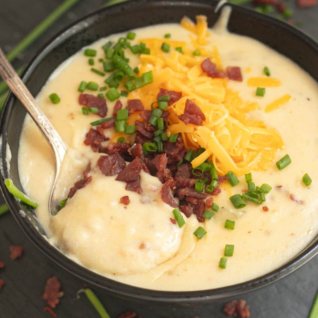 a spoon in a bowl of loaded potato soup