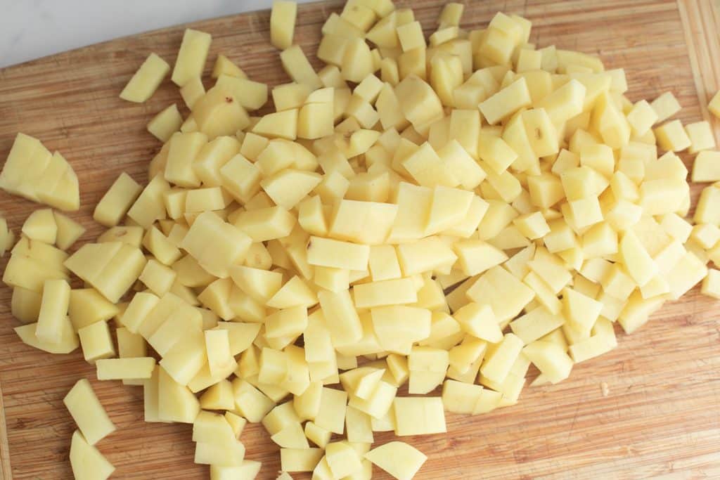 chopped potatoes on a wooden board