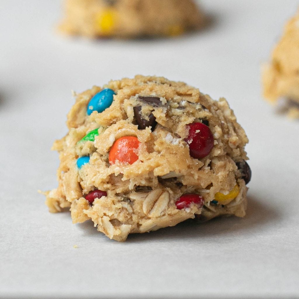 a scoop of raw cookie dough on a baking sheet