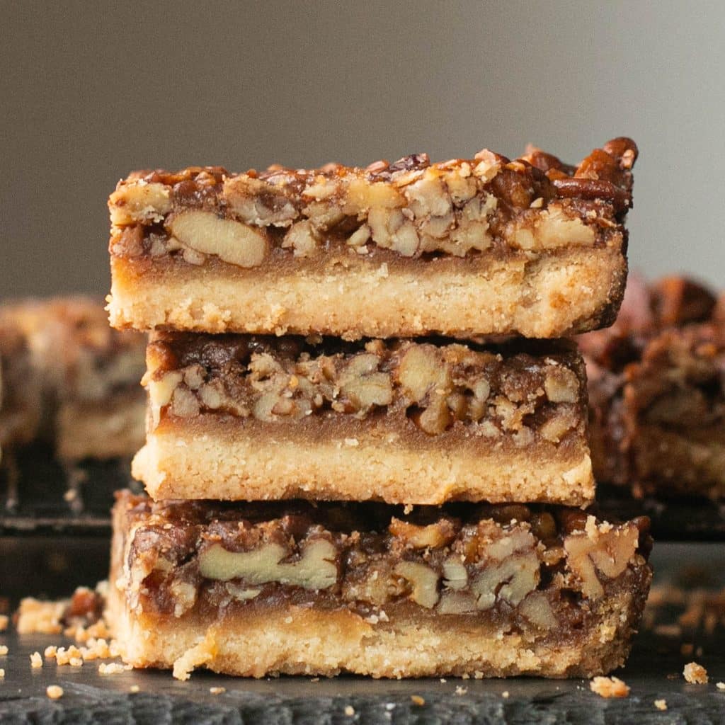 3 pecan pie bars stacked on top of each other