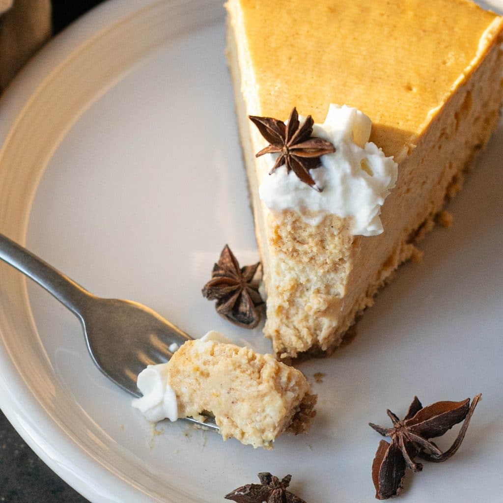 a slice of pumpkin cheesecake on a white plate