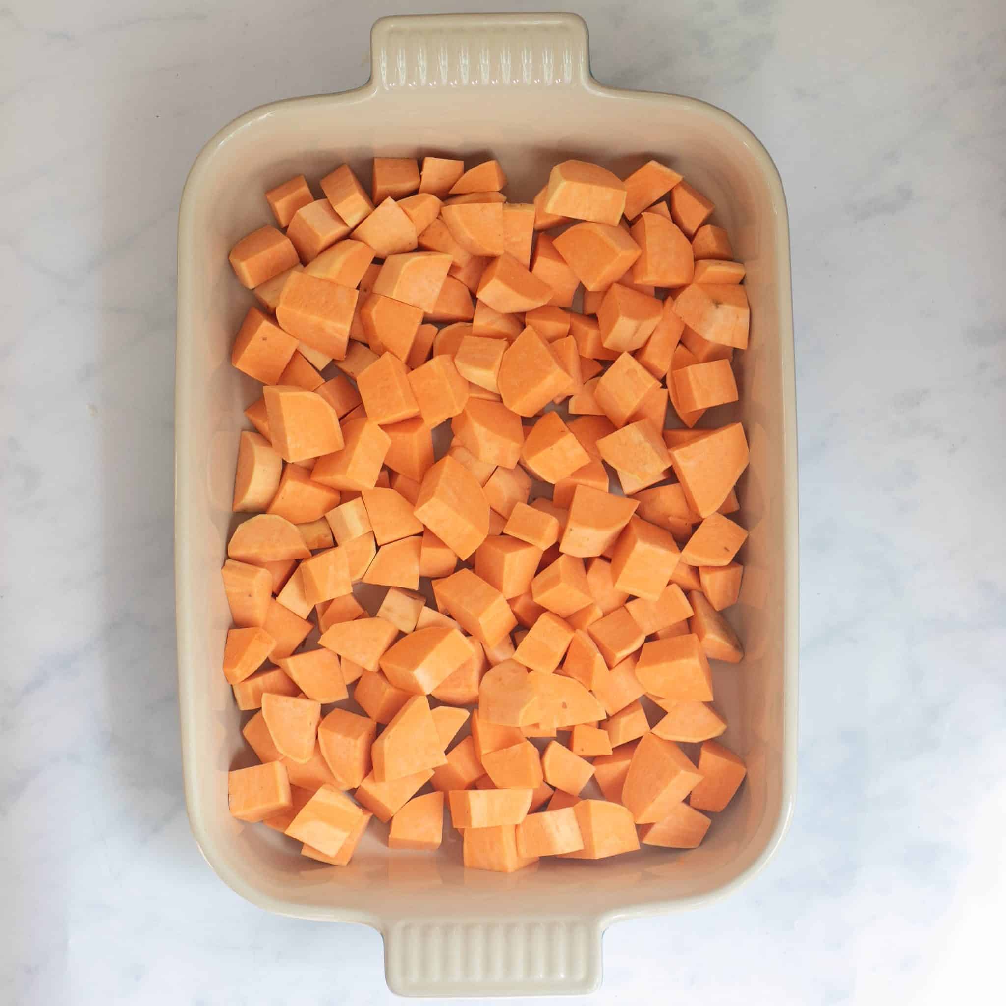 cubed raw sweet potatoes in a baking dish