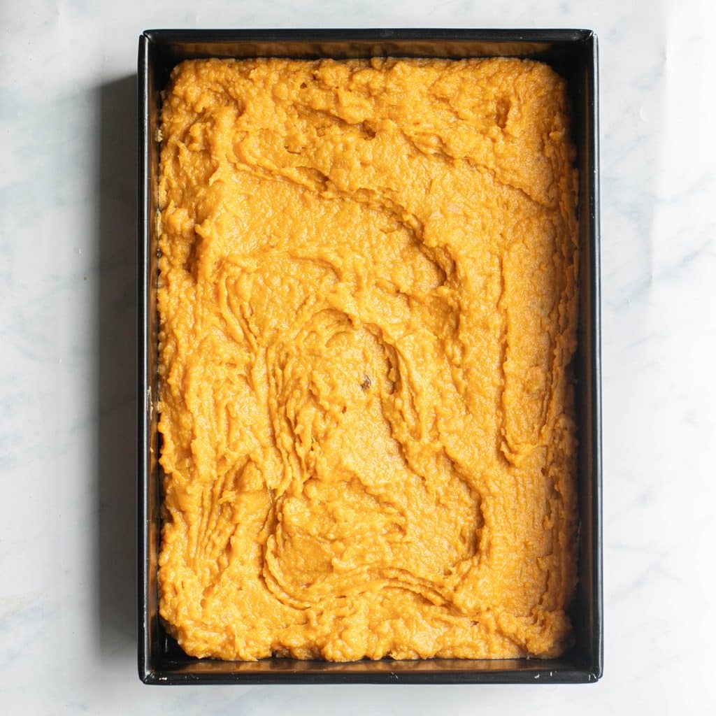 sweet potato mash spread into a black baking dish