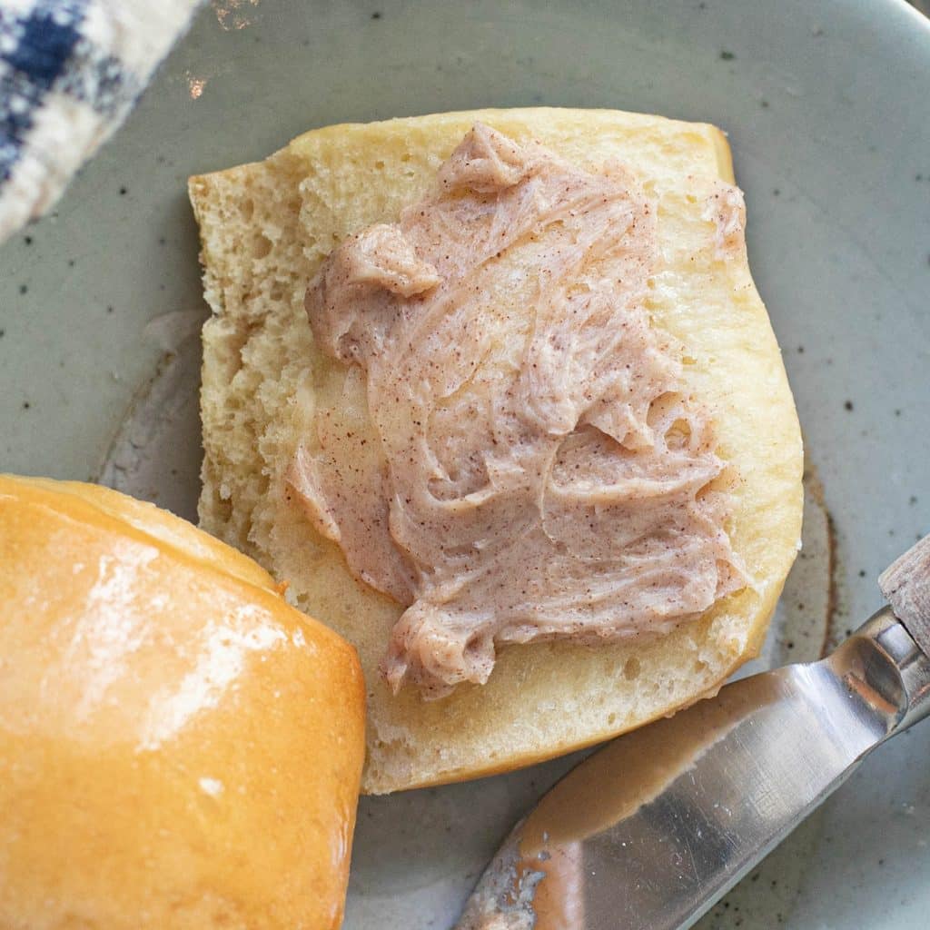 a Texas Roadhouse roll with cinnamon honey butter