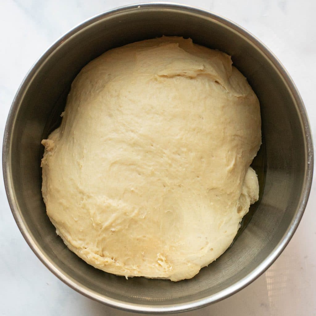 bread dough in a bowl after rising