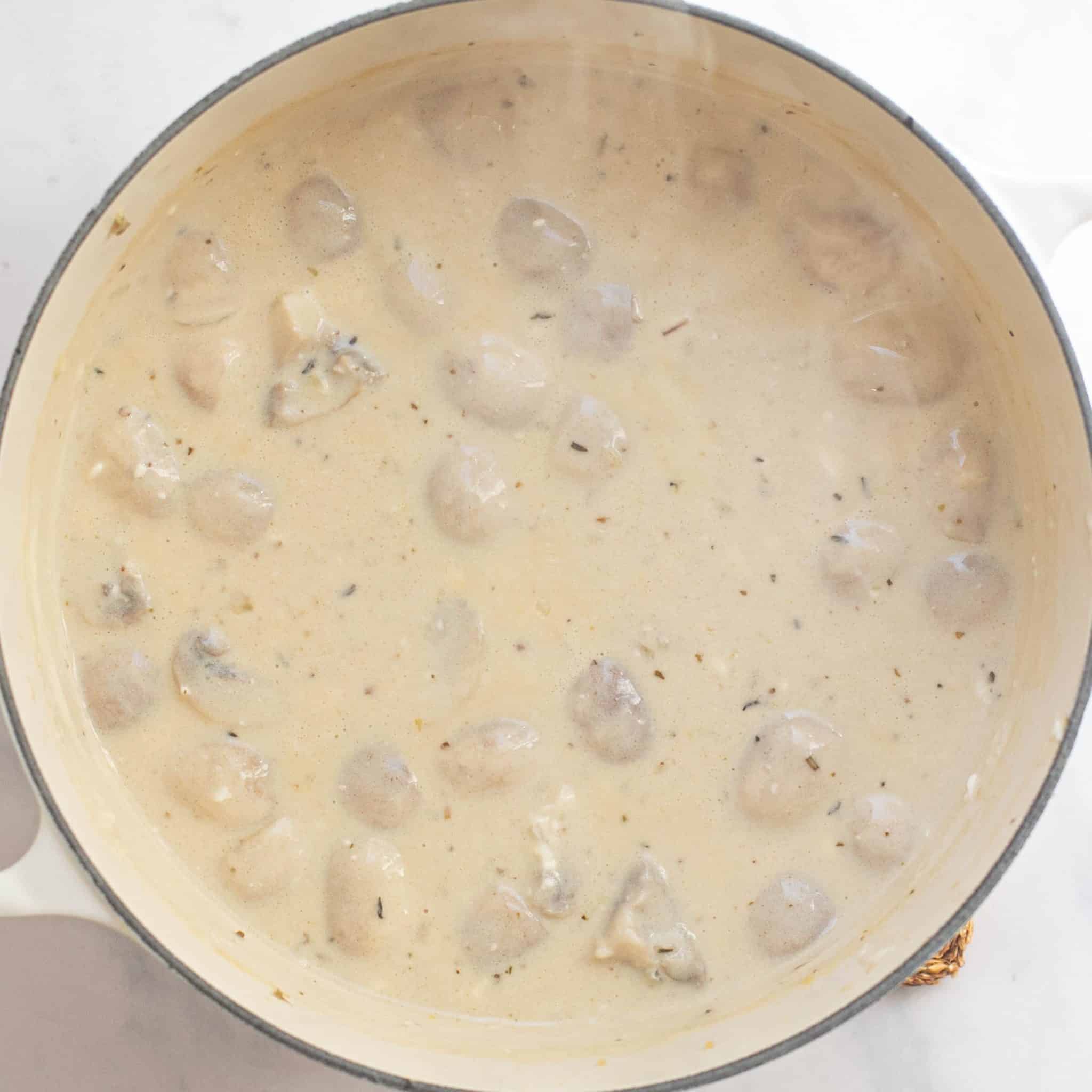 cream sauce simmering in a Dutch oven